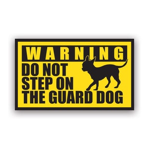 May include: A yellow and black warning sign with the text "WARNING DO NOT STEP ON THE GUARD DOG" and a silhouette of a small dog.