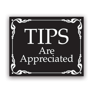 May include: A black rectangular sign with white text that reads "TIPS Are Appreciated." The sign has a white decorative border with floral and scroll designs.