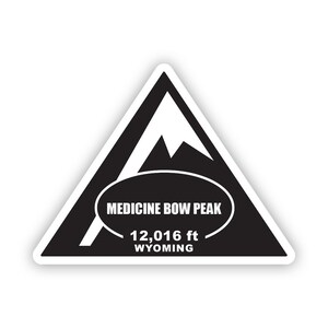 May include: Black and white triangular sticker with a mountain silhouette and the text "MEDICINE BOW PEAK 12,016 ft WYOMING".