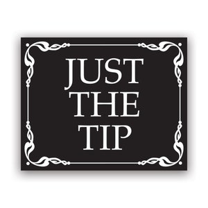 May include: Black and white sign with a decorative border. The sign reads "Just the Tip".