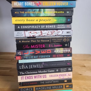 May include: A stack of 14 paperback books, mostly mystery and thriller novels, with titles like "The Wife Between Us", "Claim Your Swagger", "Heart Bones", "All the Missing Girls", "Every Bone a Prayer", "A Conspiracy of Bones", "The Mister", "All is Not Forgiven", "The Christmas Murder Game", "It Ends With Us", "The Silent Wife", "Circe", and "The Santa Suit".