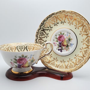 Paragon By Appointment to Her Majesty The Queen Pale Yellow Teacup and Saucer with Rose and Fruit
