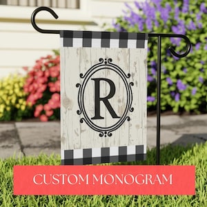 May include: A black and white checked garden flag with a whitewashed wood background. The flag features a black letter "R" in a decorative black frame. The text "CUSTOM MONOGRAM" is printed in red at the bottom of the image.