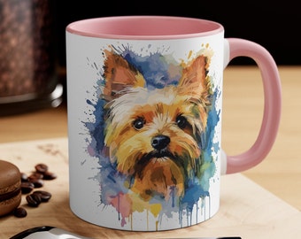 May include: A white ceramic mug with a pink rim and handle. The mug features a watercolor illustration of a Yorkshire Terrier dog with a colorful background.