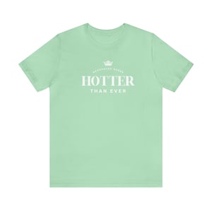 May include: A light green t-shirt with a white crown and the text "Menopause Queen" above the text "Hotter Than Ever".