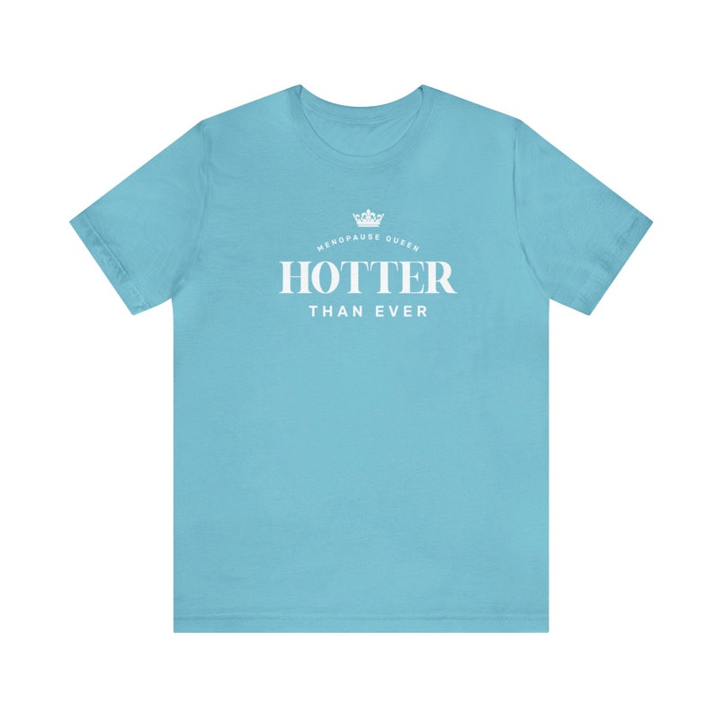 May include: A light blue t-shirt with white text that reads "Menopause Queen HOTTER THAN EVER" with a crown graphic above the text.