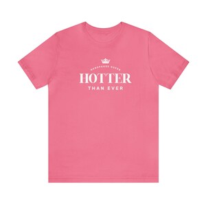 May include: Pink t-shirt with a white crown and the text "Menopause Queen" above the text "Hotter Than Ever".
