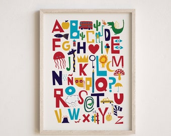 May include: A colorful alphabet poster with illustrations for each letter. The letters are in red, blue, yellow, and green. The illustrations include a fish, an apple, a bus, a cactus, a dragon, a house, a heart, an ice cream cone, a jellyfish, a crown, a key, a lion, a moon, a mushroom, a cat, a pencil, a question mark, a cloud, a rain drop, a snake, a taxi, a volcano, a worm, a yarn ball, and a zipper.