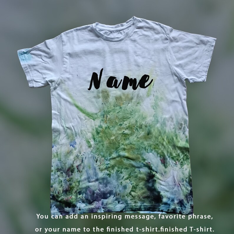 May include: A white t-shirt with a tie-dye pattern in shades of green, blue, and purple. The word "Name" is written in black on the front of the shirt.