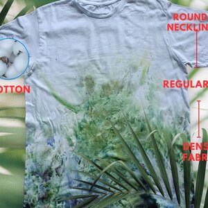 May include: A white cotton t-shirt with a round neckline and a regular fit. The shirt has a tie-dye pattern with green, blue, and white colors. The fabric is dense and has a textured look.