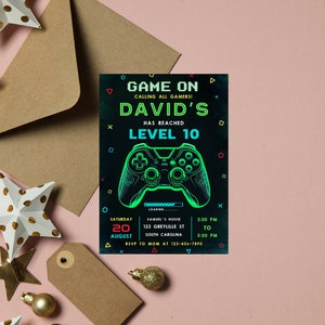May include: A black and green video game themed birthday party invitation with the text "Game On! Calling all gamers! David's has reached Level 10". The invitation includes a graphic of a video game controller and details for the party, including the date, time, and location.