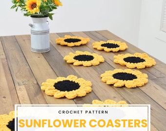 May include: Crochet pattern for sunflower coasters. Six yellow crocheted coasters with black centres are arranged on a wooden table.