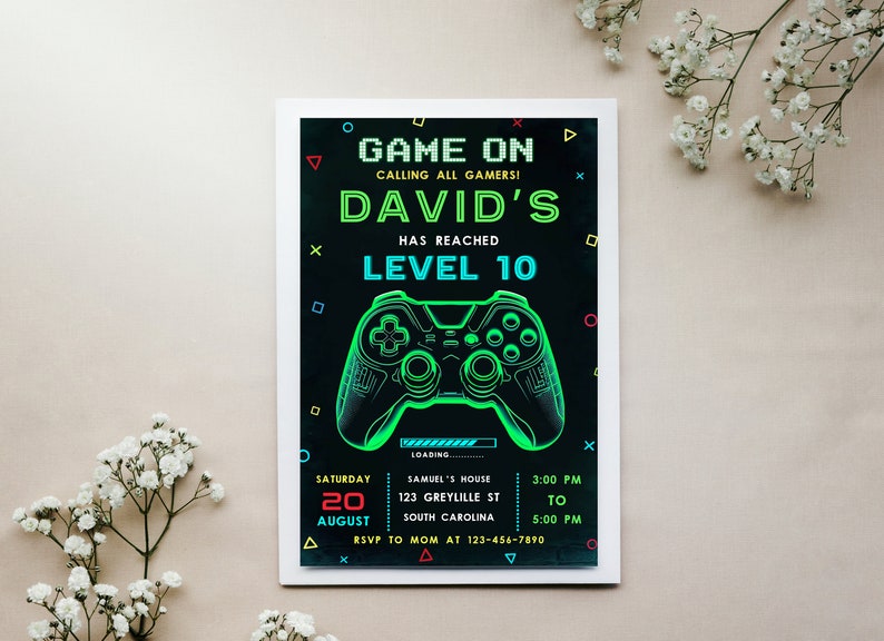 May include: A black and green video game party invitation with a neon green video game controller graphic. The invitation reads "Game On Calling All Gamers! David's Has Reached Level 10". The invitation also includes the date, time, and location of the party.