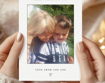 May include: A personalized Christmas card featuring a photograph of a woman and a child. The card includes the text "MERRY CHRISTMAS NAN", "LOVE FROM LOU LOU", and a heart symbol. The bottom of the card reads "Add your own photo & text".