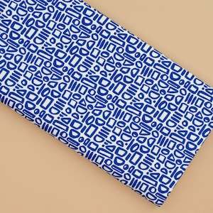 May include: White fabric with a repeating pattern of blue geometric shapes. The shapes include circles, squares, rectangles, and triangles.