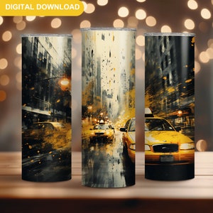 May include: A set of three 20 oz stainless steel tumblers with a yellow taxi cab design. The design features a yellow taxi cab driving down a city street with tall buildings in the background. The design is painted in a watercolor style with splashes of yellow, black, and white.
