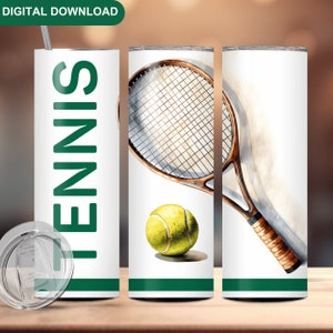 May include: A white tumbler with a green stripe and the word "TENNIS" in green letters. The tumbler is next to a white tumbler with a green stripe and a watercolor illustration of a tennis racket and ball.