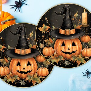 May include: Two round black plates with a gold rim, each featuring a jack-o'-lantern pumpkin wearing a black witch hat with an orange band. The pumpkins are surrounded by fall leaves and vines.
