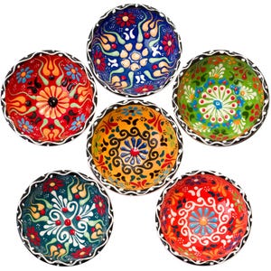 May include: Six colorful ceramic bowls with intricate floral patterns. The bowls are decorated with blue, green, yellow, red, and white paint. The bowls are perfect for serving snacks or desserts.