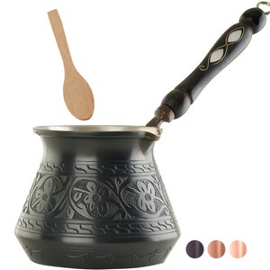 May include: Black metal coffee pot with an ornate floral design and a wooden handle. A wooden spoon is floating above the pot.