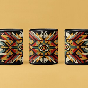 May include: Three black coffee mugs with a geometric pattern in shades of red, yellow, blue, and white. The pattern is inspired by Native American art.