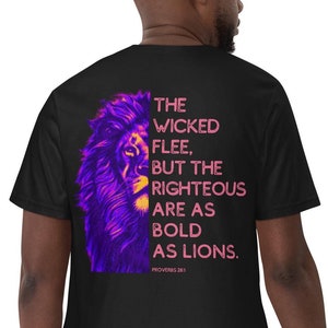 May include: A black short-sleeved t-shirt featuring a graphic on the back. The design displays a purple and orange lion's face next to the text: THE WICKED FLEE, BUT THE RIGHTEOUS ARE AS BOLD AS LIONS. PROVERBS 28:1 in pink and orange lettering.