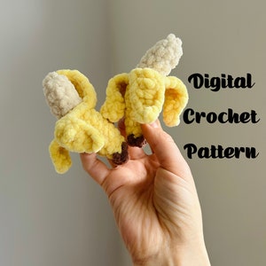 May include: A crocheted banana plush toy in yellow and brown. The toy is held in a hand. The text "Digital Crochet Pattern" is written in black on a white background.