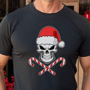 May include: Black t-shirt featuring a skull wearing a Santa hat and crossed candy canes. The graphic is in white, red, and black. The shirt is a crew neck and appears to be made of cotton.