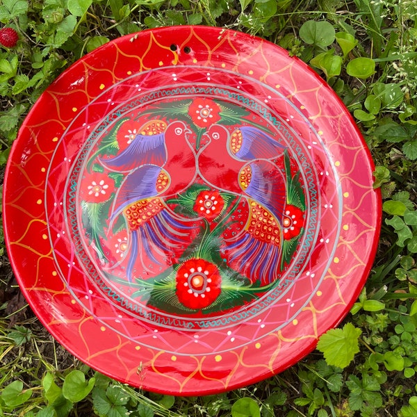 Red authentic art piece with birds. Bright and colorful Mexican pottery plate.