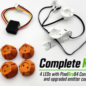 May include: A complete kit featuring a black PixelBro84 controller with multi-colored wiring, four white LED light housings connected by black wires, four orange ribbed emitter cones, and three small clear wire connectors on a white background.