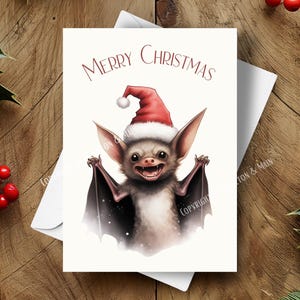 Cartão de Natal de morcego, Morcego de Natal fofo e assustador usando um chapéu de Papai Noel, Cena de inverno com neve, Ilustração de arte em aquarela, Saudação de feriado exclusiva