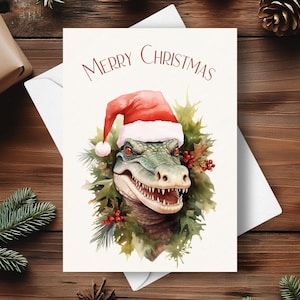 Cartão de Natal de jacaré, usando um chapéu de Papai Noel e guirlanda de poinsétia vermelha, presente de Natal para a vida selvagem da Flórida, ilustração de arte em aquarela