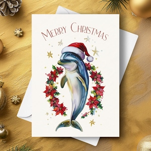 Delfin Weihnachtskarte, mit Weihnachtsmütze und roter Weihnachtsstern-Girlande, niedliches Ozeantier im Meer, Urlaub Geschenk, Aquarell Kunst Illustration