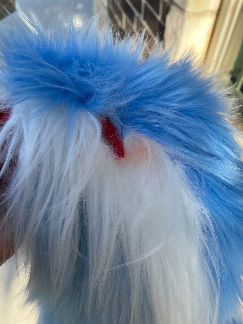 Puede incluir: Una cola de piel sint&eacute;tica azul y blanca esponjosa. La cola est&aacute; hecha de tela suave y afelpada y tiene un dise&ntilde;o largo y fluido.