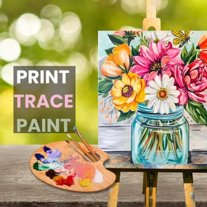 May include: A painting of a bouquet of flowers in a mason jar. The flowers are pink, yellow, and white. The painting is on a canvas and is on an easel. The words "PRINT TRACE PAINT" are written on a pink and white sign.