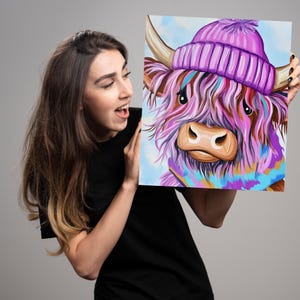 May include: A painting of a Highland cow with pink and purple fur wearing a purple beanie and a blue and purple scarf. The cow is looking directly at the viewer.