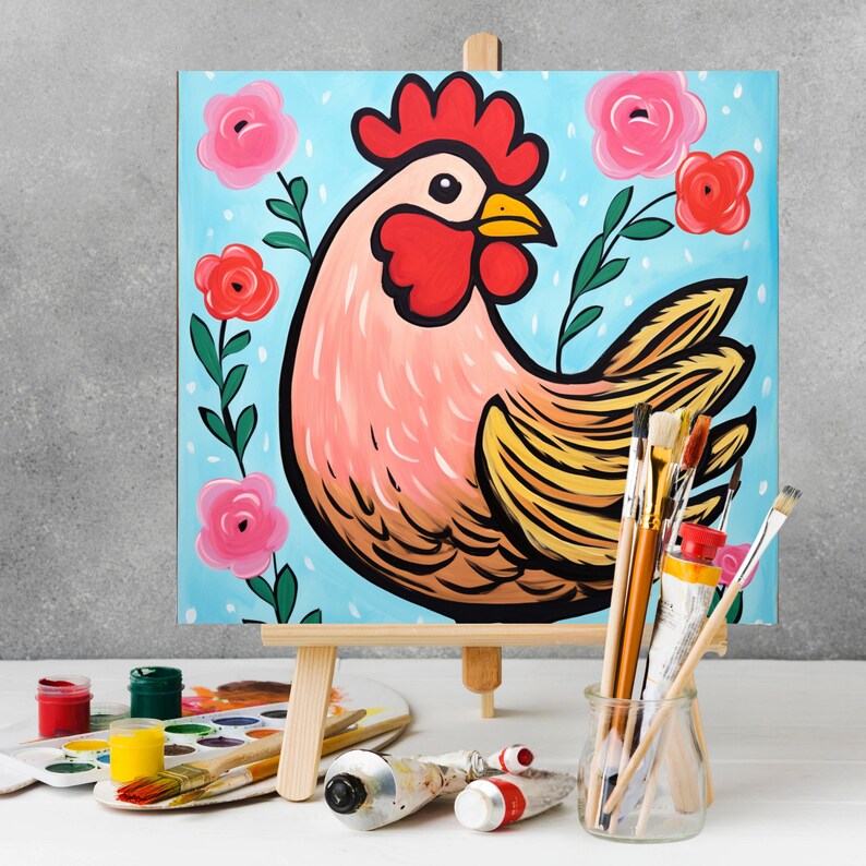 May include: A painting of a rooster with a red comb and wattle, yellow feathers, and a blue background. The rooster is surrounded by pink flowers and green leaves. The painting is on an easel with paintbrushes and paint tubes in front of it.