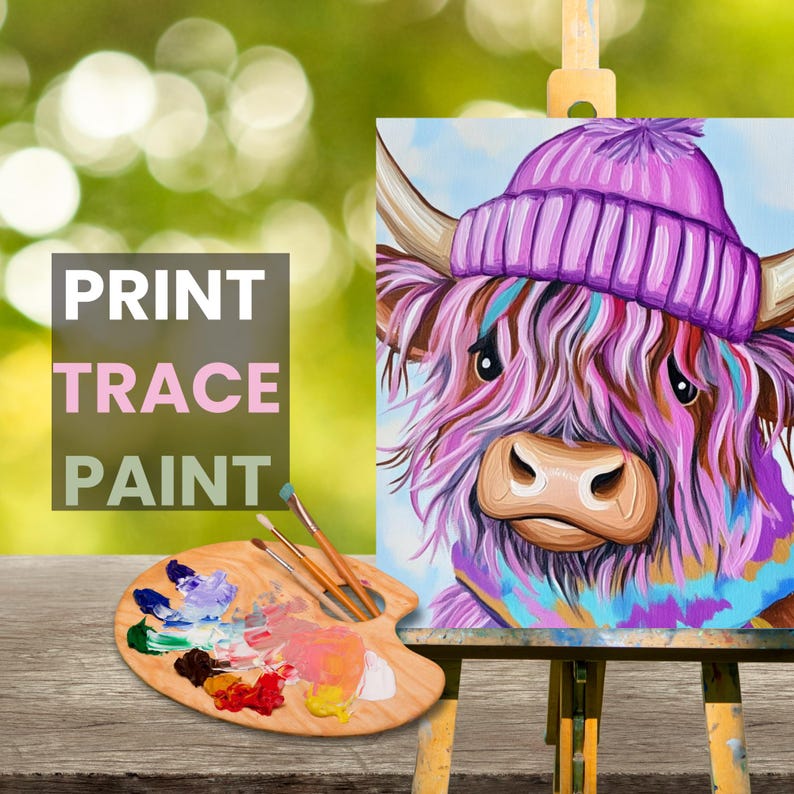 May include: A painting of a Highland cow wearing a purple knitted hat and a blue scarf. The cow has pink and white fur and brown eyes. The painting is on a canvas and is on an easel. The words "PRINT TRACE PAINT" are visible in the image.