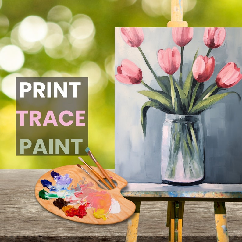 May include: A painting of pink tulips in a glass vase on a wooden easel. The painting is on a canvas and has a light blue background. The easel is on a wooden table. There is a wooden paint palette with paint on it and three paintbrushes on the table. The text "PRINT TRACE PAINT" is on the left side of the image.