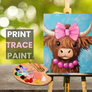 May include: A painting of a brown Highland cow with a pink bow and pink beads around its neck. The painting is on a canvas and is on an easel. The words "PRINT TRACE PAINT" are in the lower left corner of the image.