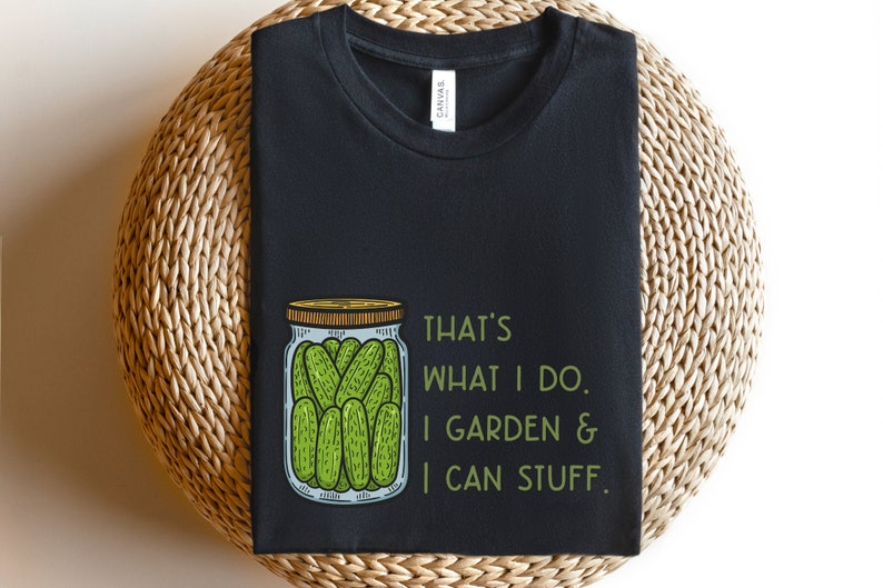 May include: Black t-shirt with a green and white illustration of a jar of pickles. The text "That's what I do. I garden & I can stuff." is printed on the shirt.