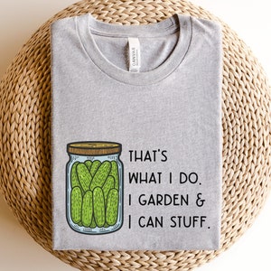 May include: Gray t-shirt with a drawing of a jar of pickles and the text "That's what I do. I garden & I can stuff."