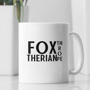 May include: White ceramic mug with black text that reads "FOX THERIANPE" with the letters "THROP" rotated 90 degrees clockwise.