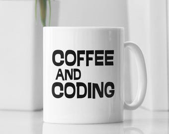 May include: White ceramic coffee mug with black text that reads "Coffee and Coding".