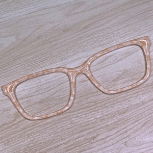 May include: A pair of beige eyeglasses with a tortoise shell pattern. The glasses have a square frame and are made of plastic.