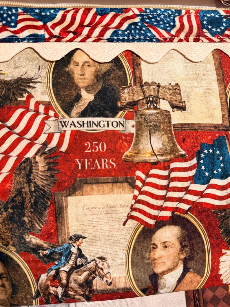 May include: A patriotic fabric featuring American flags, portraits of George Washington, the Liberty Bell, and an eagle. The design includes the text "WASHINGTON 250 YEARS" and a section of the U.S. Constitution.