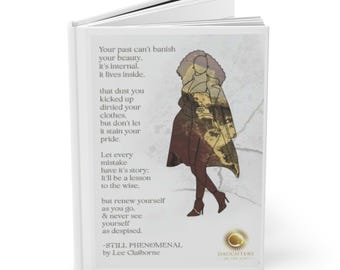 May include: A white book with a black and gold illustration of a woman wearing a long coat and high heels. The book has the text "Your past can't banish your beauty. It's internal. It lives inside." and "Let every mistake have it's story: It'll be a lesson to the wise." and "Still, Phenomenal by Lee Claiborne" on the cover.