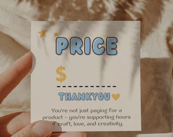 May include: A cream-colored card with the word "PRICE" in blue bubble letters, a dollar sign, and the word "THANKYOU" in blue. The card includes text about supporting craft, love, and creativity.