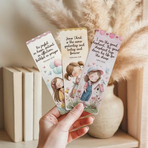 May include: Three illustrated bookmarks with inspirational quotes and images of girls. The bookmarks feature text from Romans 12:12, Hebrews 13:8, and John 10:11. Each bookmark has a different design with pastel colors and floral accents.