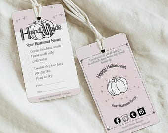 May include: Two light pink handmade product tags with white string. One tag features care instructions and space for price and size. The other tag says "Happy Halloween" with social media icons and a pumpkin illustration.